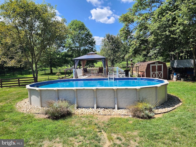 view of swimming pool with a lawn, a storage shed, and a gazebo