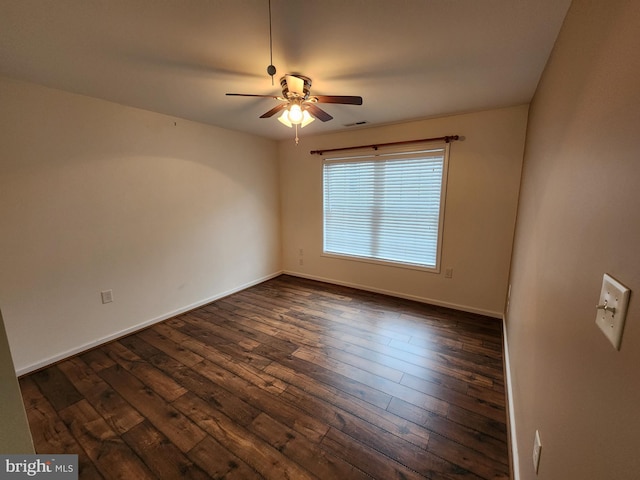 empty room featuring ceiling fan and dark wood-type flooring