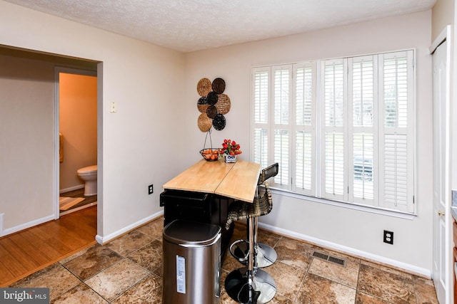 dining area featuring a textured ceiling