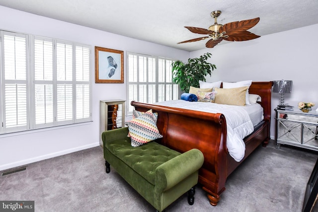 bedroom featuring carpet floors and a textured ceiling