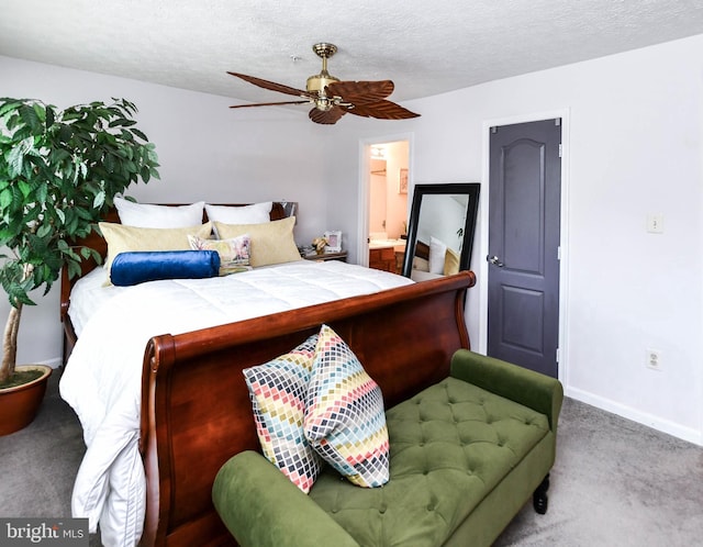 bedroom with ceiling fan, carpet, a textured ceiling, and ensuite bath