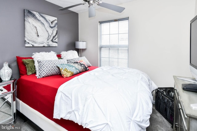 bedroom with ceiling fan and dark colored carpet