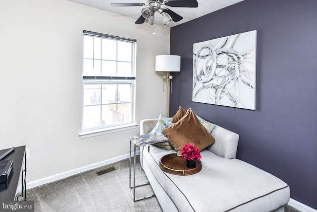 sitting room featuring carpet floors and ceiling fan