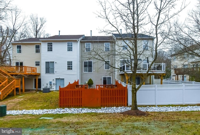 back of house with a wooden deck and a yard