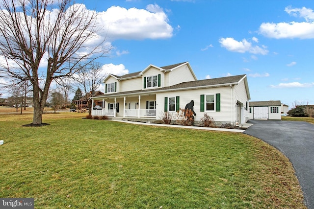 view of front of property with a porch, a garage, and a front yard