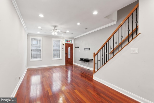 entryway with hardwood / wood-style floors, crown molding, and ceiling fan