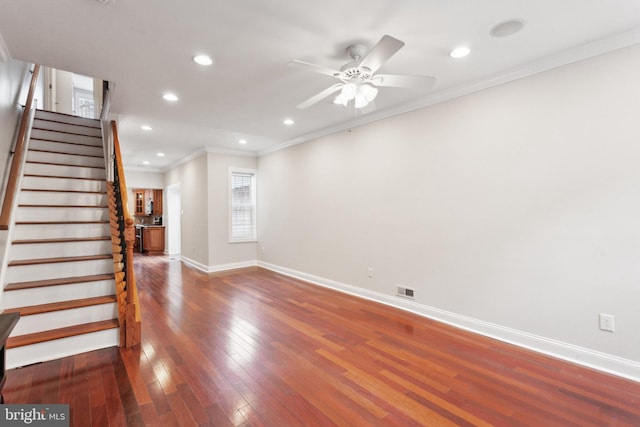 interior space featuring ornamental molding, dark hardwood / wood-style floors, and ceiling fan