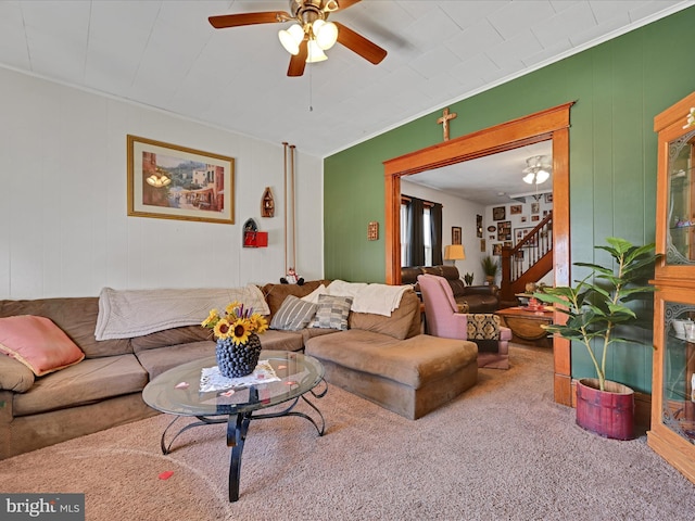 living room featuring carpet floors, ornamental molding, and ceiling fan