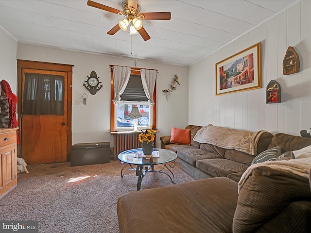 living room with radiator, ceiling fan, and carpet