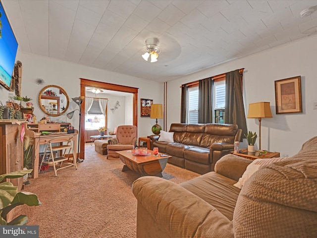 carpeted living room with ceiling fan