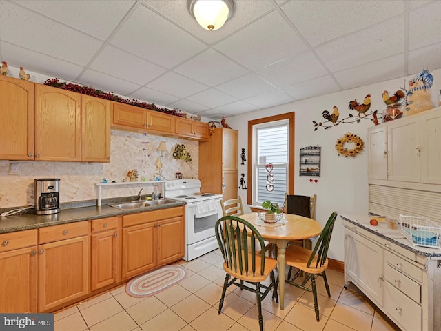 kitchen featuring electric stove, sink, light tile patterned floors, a drop ceiling, and decorative backsplash