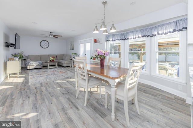 dining room with ceiling fan, light wood-type flooring, and french doors