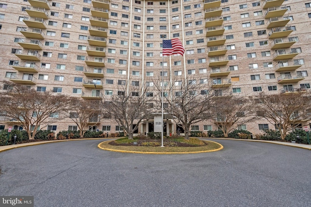 view of building exterior with aphalt driveway