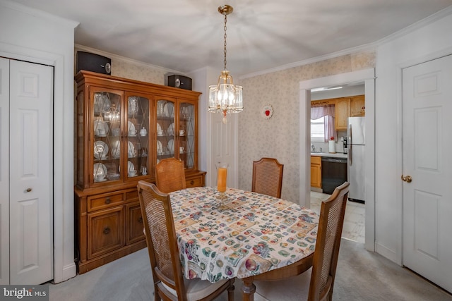 dining space with ornamental molding, light carpet, and a chandelier