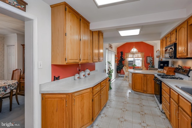 kitchen with hanging light fixtures, range with gas cooktop, kitchen peninsula, and vaulted ceiling