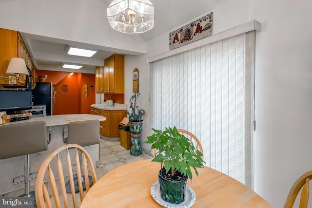 dining space featuring a notable chandelier