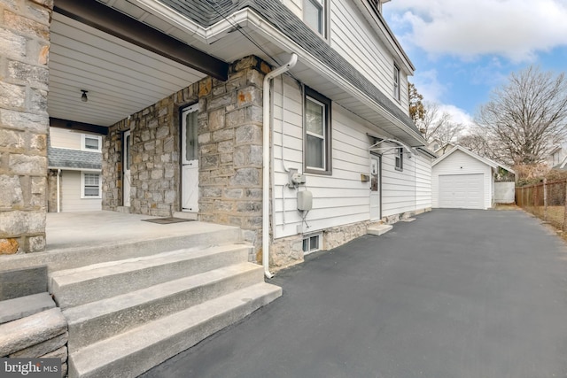 view of side of property featuring a garage and an outdoor structure