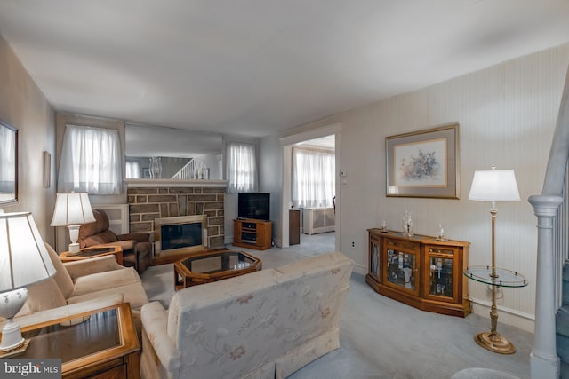 carpeted living room with a fireplace and a wealth of natural light