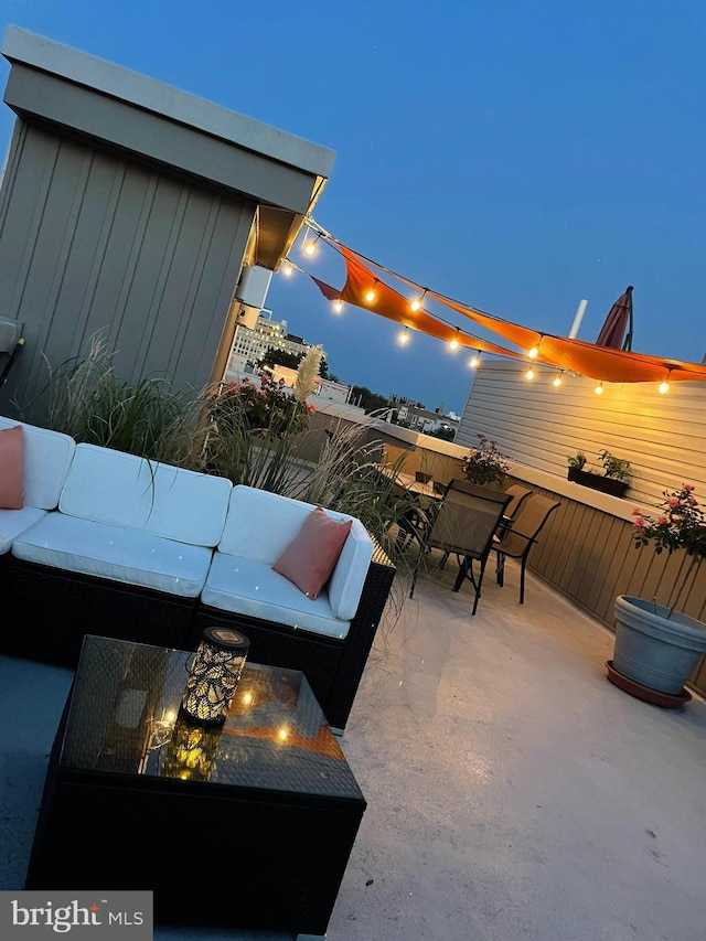 view of patio with a water view and outdoor lounge area