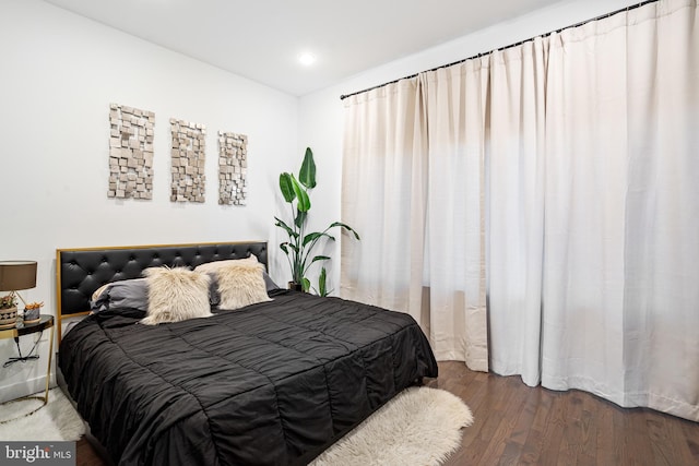 bedroom with dark wood-type flooring