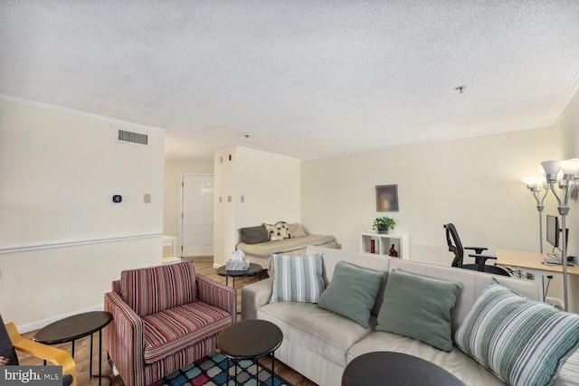 living room featuring hardwood / wood-style floors, crown molding, and a textured ceiling