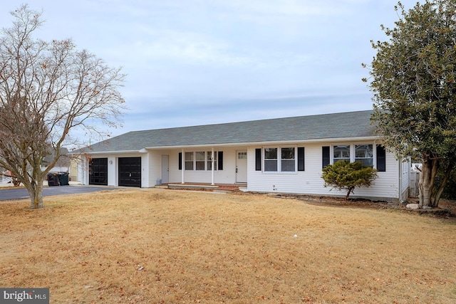 ranch-style home featuring a front lawn and a garage