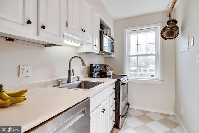 kitchen with stainless steel appliances, sink, and white cabinets