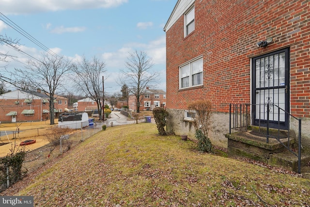 view of yard with a residential view and fence