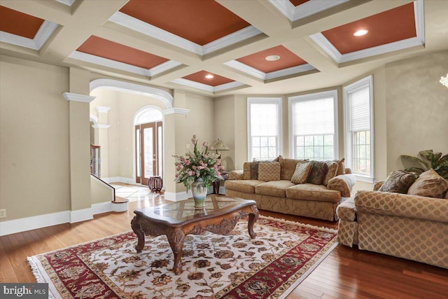 living room with a healthy amount of sunlight, coffered ceiling, and wood-type flooring