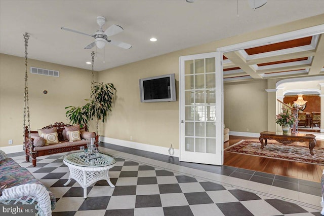 living room featuring beamed ceiling, coffered ceiling, ceiling fan, and french doors