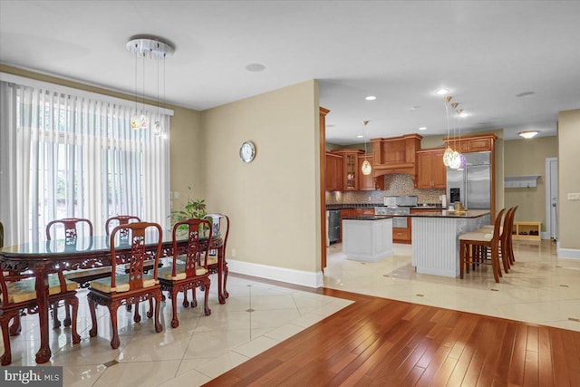 dining space with light wood-type flooring