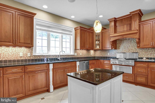 kitchen with sink, tasteful backsplash, decorative light fixtures, dark stone countertops, and dishwasher