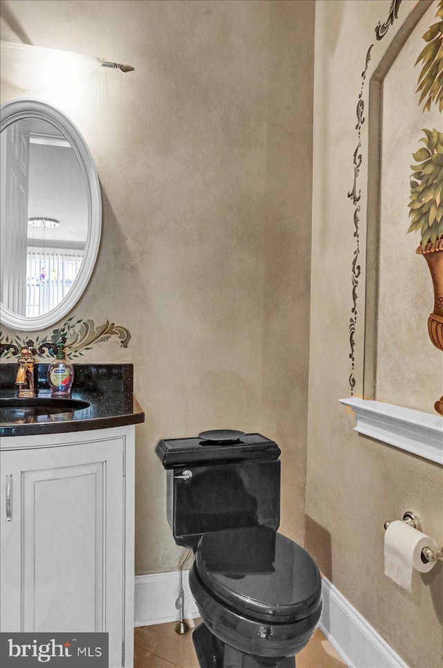 bathroom with vanity, tile patterned flooring, and toilet