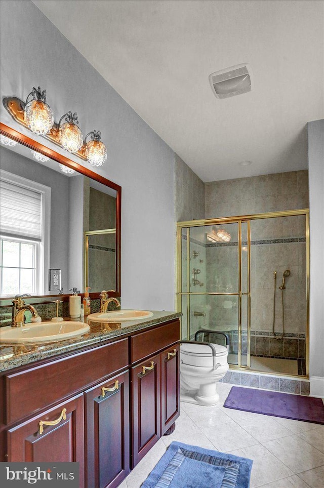 bathroom with walk in shower, vanity, toilet, and tile patterned flooring