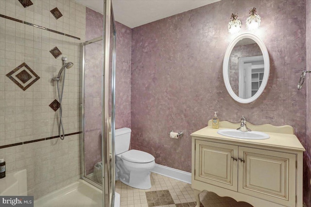 bathroom with a shower with door, vanity, and toilet