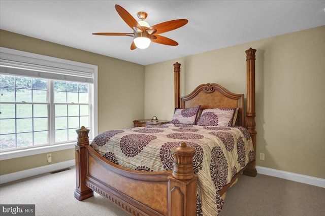 bedroom featuring light colored carpet and ceiling fan