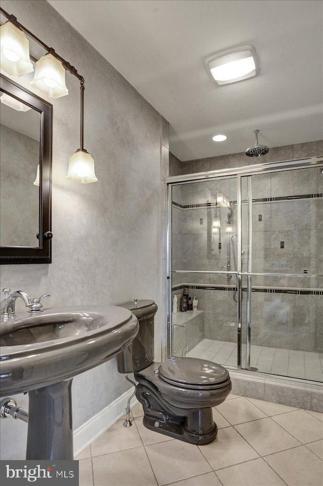 bathroom featuring tile patterned flooring, toilet, and walk in shower