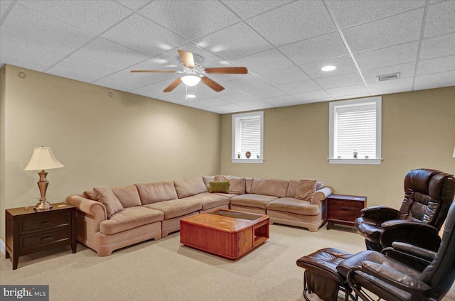 carpeted living room with a paneled ceiling and ceiling fan