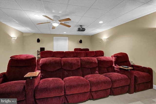 cinema with a paneled ceiling and ceiling fan