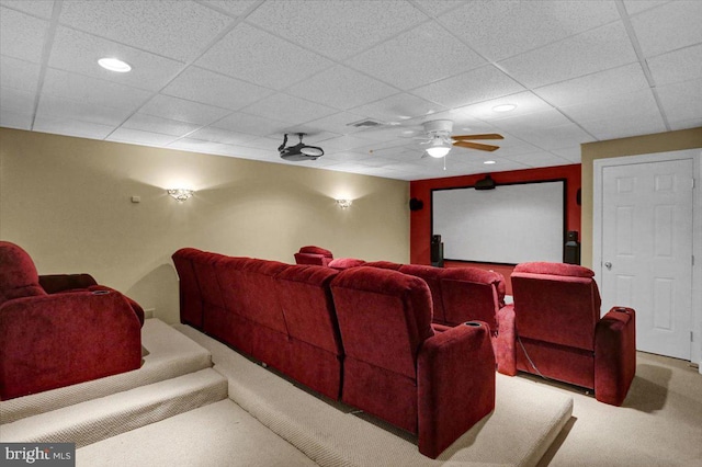 cinema with carpet flooring, a drop ceiling, and ceiling fan