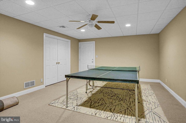 playroom featuring a drop ceiling, carpet floors, and ceiling fan