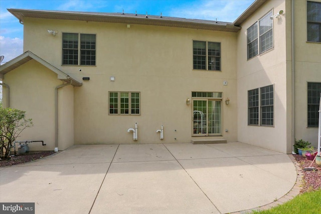 rear view of property featuring a patio