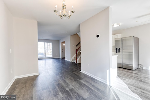 interior space with hardwood / wood-style floors and an inviting chandelier