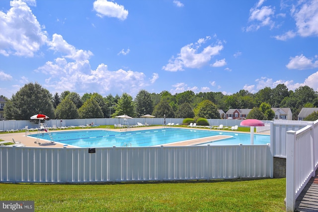 view of pool with a lawn