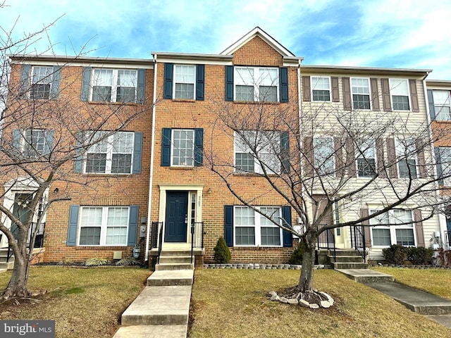 view of property featuring a front lawn