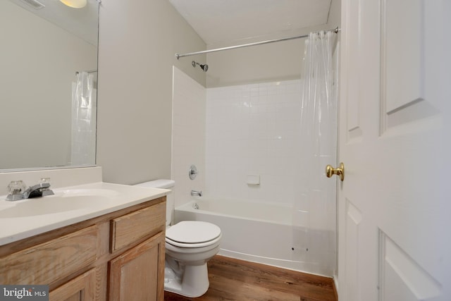 full bathroom with shower / bathtub combination with curtain, vanity, toilet, and hardwood / wood-style floors