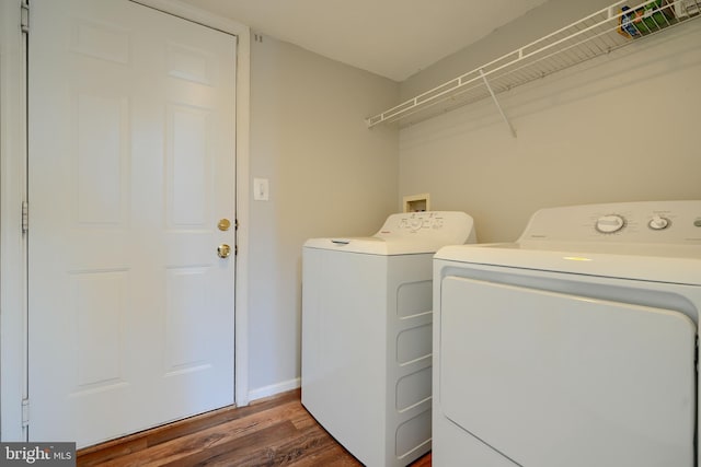 laundry area with washing machine and dryer and dark hardwood / wood-style floors