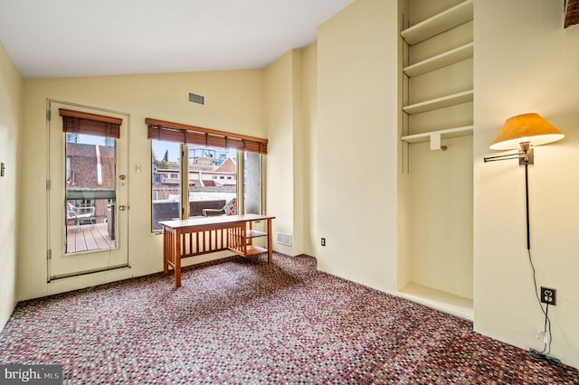 interior space with lofted ceiling and carpet flooring