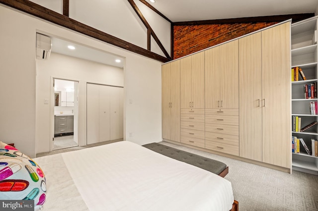 carpeted bedroom featuring lofted ceiling, connected bathroom, and a wall unit AC