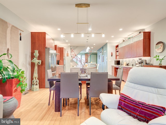 dining room with light wood-type flooring